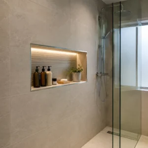 Bathroom corner shelves with baskets, towels and toiletries creating organised storage in a small space.